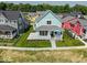 Light-blue home features a porch, neatly manicured lawn, sidewalk and colorful adjacent houses at 5421 Upper Garden Way, Zionsville, IN 46077