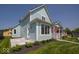 Two-story house with light blue siding, well-manicured lawn, and a detached two-car garage at 5421 Upper Garden Way, Zionsville, IN 46077