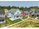 Light-blue home, neat lawn, front porch and surrounded by various color homes with grassy yards at 5421 Upper Garden Way, Zionsville, IN 46077