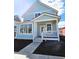 Charming light blue two-story home with a welcoming front porch and large windows at 5421 Upper Garden Way, Zionsville, IN 46077