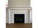 Bright fireplace with white brick, white mantle, and black firebox at 5421 Upper Garden Way, Zionsville, IN 46077