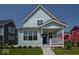 Charming two-story home with light blue siding, a cozy front porch, and well-maintained landscaping at 5421 Upper Garden Way, Zionsville, IN 46077