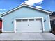 Detached garage featuring a white carriage door, adding to the property's curb appeal at 5421 Upper Garden Way, Zionsville, IN 46077