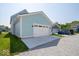 Detached two-car garage featuring a concrete driveway and manicured lawn at 5421 Upper Garden Way, Zionsville, IN 46077