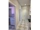 Hallway with doors and cabinets with matching neutral diamond tile floor at 5421 Upper Garden Way, Zionsville, IN 46077