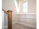 Brightly lit hallway with built in shelves and wooden handrail at 5421 Upper Garden Way, Zionsville, IN 46077