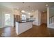 Modern kitchen with stainless steel appliances, island, and hardwood floors at 5421 Upper Garden Way, Zionsville, IN 46077