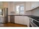 Elegant kitchen with stainless appliances, white cabinets and dark countertops at 5421 Upper Garden Way, Zionsville, IN 46077