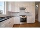 Gourmet kitchen featuring stainless steel oven and range with custom hood at 5421 Upper Garden Way, Zionsville, IN 46077