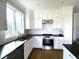 Kitchen with stainless steel appliances, white cabinets, and subway tile backsplash at 5421 Upper Garden Way, Zionsville, IN 46077