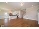 Open-concept living space features hardwood floors and seamless access to the kitchen and stairway at 5421 Upper Garden Way, Zionsville, IN 46077