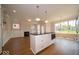 Open living space with kitchen island, fireplace, and plenty of natural light at 5421 Upper Garden Way, Zionsville, IN 46077