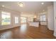 Open-concept living room and kitchen with hardwood floors and abundant natural light at 5421 Upper Garden Way, Zionsville, IN 46077