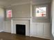 Living room featuring a white brick fireplace, white cabinets, and natural light at 5421 Upper Garden Way, Zionsville, IN 46077
