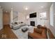 Sophisticated living room with a fireplace, large TV, and stylish decor at 5421 Upper Garden Way, Zionsville, IN 46077