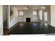 Bright living room with fireplace, white cabinets and trim, and hardwood floors at 5421 Upper Garden Way, Zionsville, IN 46077