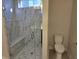 Luxurious shower with marble tiling, a built-in bench, and a glass enclosure at 5421 Upper Garden Way, Zionsville, IN 46077