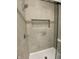 Modern shower with tiled walls, recessed niche, and glass door at 5421 Upper Garden Way, Zionsville, IN 46077