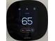 Close-up of the ecobee smart thermostat displaying the current temperature of 65 degrees at 5421 Upper Garden Way, Zionsville, IN 46077