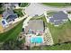 Aerial view of a house featuring a swimming pool and patio area surrounded by well-manicured lawns at 5683 Oakmont Blvd, Bargersville, IN 46106
