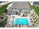Stunning aerial view of backyard featuring a large swimming pool, patio with outdoor kitchen, and well-manicured lawn at 5683 Oakmont Blvd, Bargersville, IN 46106