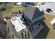 Aerial view of the backyard, showcasing the covered pool, cabana, pond, garden and red shed at 5683 Oakmont Blvd, Bargersville, IN 46106