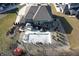 Aerial view of the backyard featuring a covered pool, cabana, a pond, and charming red shed at 5683 Oakmont Blvd, Bargersville, IN 46106