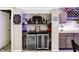 Finished basement bar with custom sports memorabilia shelving, granite countertops, and wine storage at 5683 Oakmont Blvd, Bargersville, IN 46106