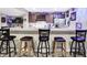 Basement bar with marble countertops, dark cabinetry, and a stainless steel refrigerator at 5683 Oakmont Blvd, Bargersville, IN 46106
