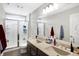 Bright bathroom with double vanity, granite countertops, shower with glass door, and ample storage at 5683 Oakmont Blvd, Bargersville, IN 46106