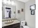 Well-lit bathroom with modern fixtures, framed mirrors, and decorative artwork on the walls at 5683 Oakmont Blvd, Bargersville, IN 46106