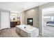 Bathroom featuring a large soaking tub, fireplace and vanity area at 5683 Oakmont Blvd, Bargersville, IN 46106