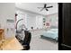 Bedroom with a ceiling fan, a decorative shelf for books and posters, and a hanging chair at 5683 Oakmont Blvd, Bargersville, IN 46106