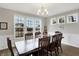 Dining room features a dark wood table, chair set, and bright windows at 5683 Oakmont Blvd, Bargersville, IN 46106