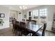 Bright dining room with a dark wood table, chair set, and large windows at 5683 Oakmont Blvd, Bargersville, IN 46106