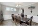 Dining room featuring a dark wood table, chairs, and three windows at 5683 Oakmont Blvd, Bargersville, IN 46106