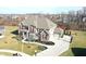 Aerial view of a two-story brick and siding home with well-manicured landscaping and attached garage at 5683 Oakmont Blvd, Bargersville, IN 46106
