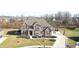 Aerial view of a two-story brick and siding home with well-manicured landscaping and a private driveway at 5683 Oakmont Blvd, Bargersville, IN 46106