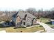 Aerial view of a charming home featuring brick, siding, manicured lawns, and a private driveway at 5683 Oakmont Blvd, Bargersville, IN 46106