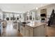 Bright kitchen features a large island with granite countertops, stainless steel appliances and a breakfast nook at 5683 Oakmont Blvd, Bargersville, IN 46106