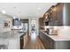 Spacious kitchen boasts dark wood cabinets, stainless steel appliances and a center island with granite countertop at 5683 Oakmont Blvd, Bargersville, IN 46106