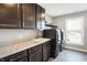 Laundry room featuring marbled countertops, cabinets, sink, a washer, and a dryer at 5683 Oakmont Blvd, Bargersville, IN 46106
