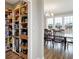 Pantry and dining room area with a long dark wood table and bright windows at 5683 Oakmont Blvd, Bargersville, IN 46106