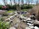 Charming backyard pond with a waterfall and lush landscaping, creating a serene and tranquil atmosphere at 5683 Oakmont Blvd, Bargersville, IN 46106