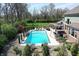 Aerial shot of the pristine pool and backyard with mature trees, perfect for summer enjoyment at 5683 Oakmont Blvd, Bargersville, IN 46106