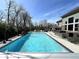 Beautiful in-ground swimming pool with clear blue water, surrounded by a patio, perfect for relaxation and entertainment at 5683 Oakmont Blvd, Bargersville, IN 46106