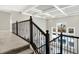 A carpeted staircase with decorative wrought iron railing and coffered ceiling detail at 5683 Oakmont Blvd, Bargersville, IN 46106
