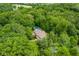 Aerial view of a home with a private pool surrounded by dense, mature trees, offering seclusion and natural beauty at 5977 S 800 E, Zionsville, IN 46077