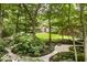 Scenic backyard view featuring stone paths, a lush lawn, mature trees, and a partial view of the home at 5977 S 800 E, Zionsville, IN 46077