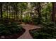 Stone patio with inviting seating area nestled within a lush, wooded backyard, creating a serene outdoor retreat at 5977 S 800 E, Zionsville, IN 46077